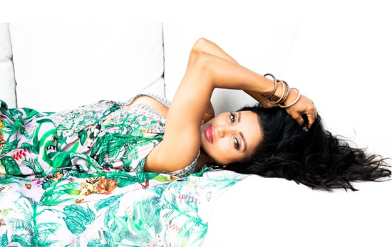 A woman in a floral dress on a white couch