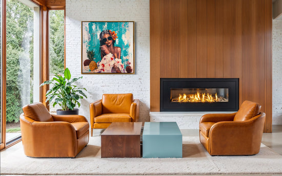 A piece of artwork hanging in a white and brown room with a fireplace