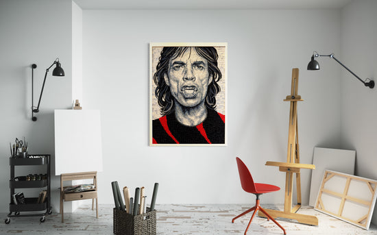 A piece of art hanging in a white-walled studio